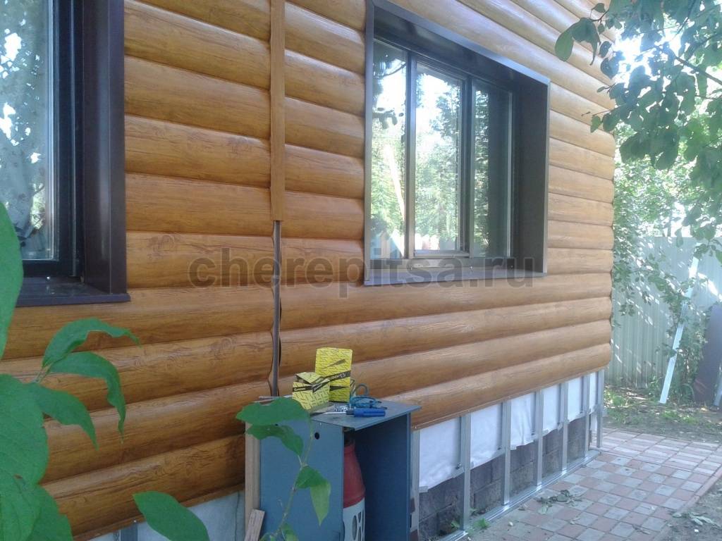 Оконная отделка на фасаде с металлическим сайдингом под бревно